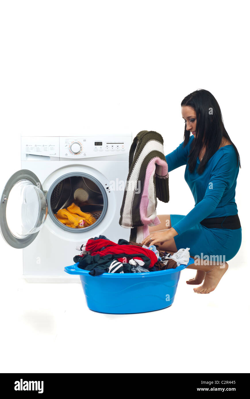 Housewife preparing to wash laundry isolated on white background Stock Photo