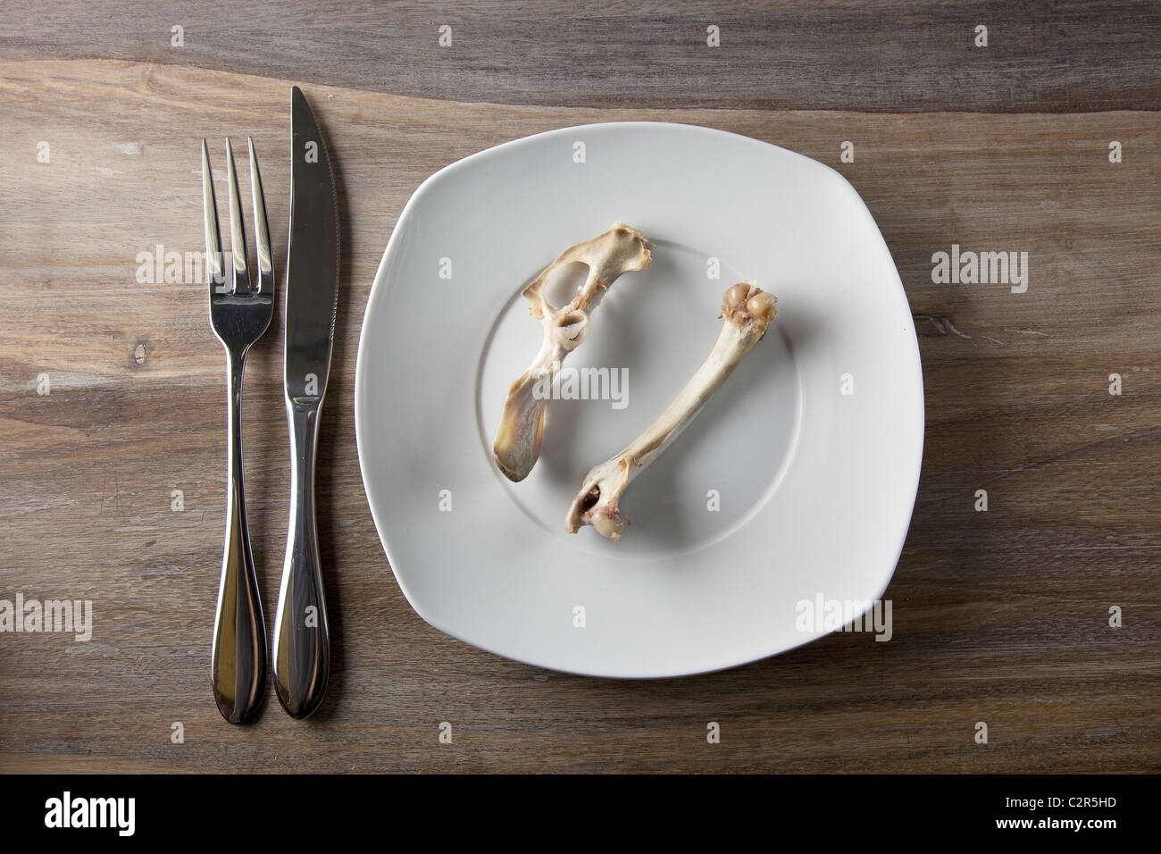 Empty dinner plate with bones Stock Photo - Alamy
