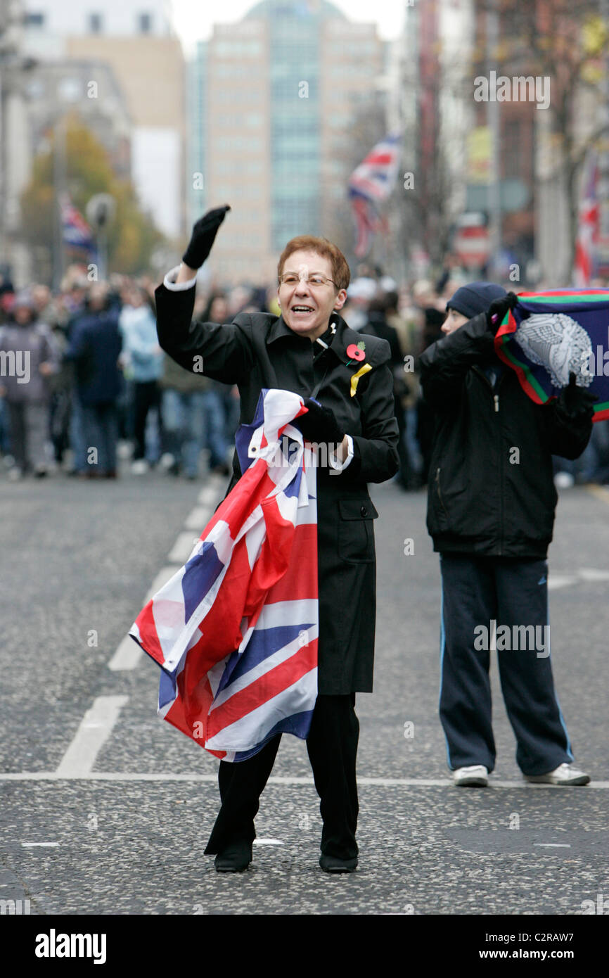 A female loyalist supporter with union flag at the Royal Irish Regiment RIR Homecoming Parade in Belfast Stock Photo