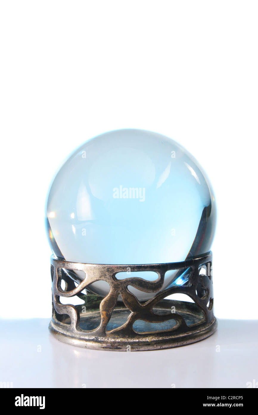 Blue light in a crystal ball in stand against a white background Stock Photo