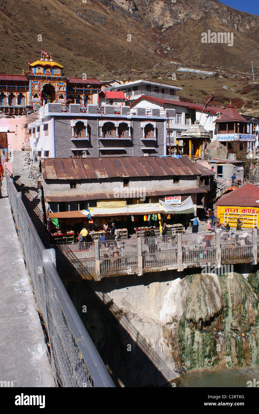Garhwal Himalayas, India: A view of the Badrinath Temple complext, viewed from a bridge spanning the Alakananda river. Stock Photo