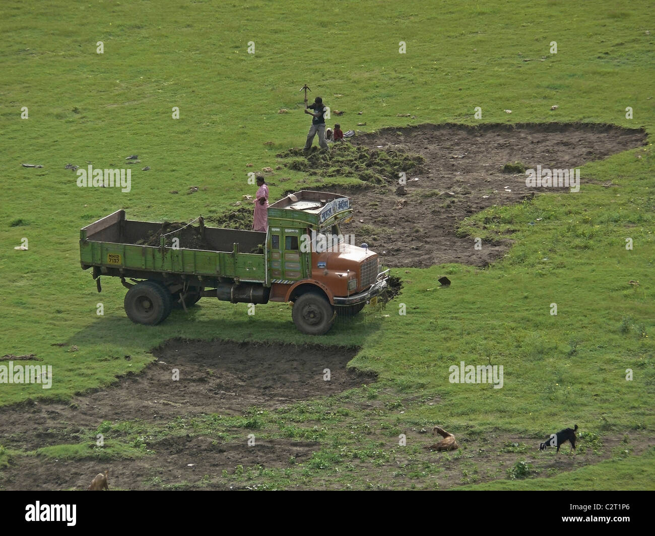 Workers are Uploading Soil in a lorry, India Stock Photo
