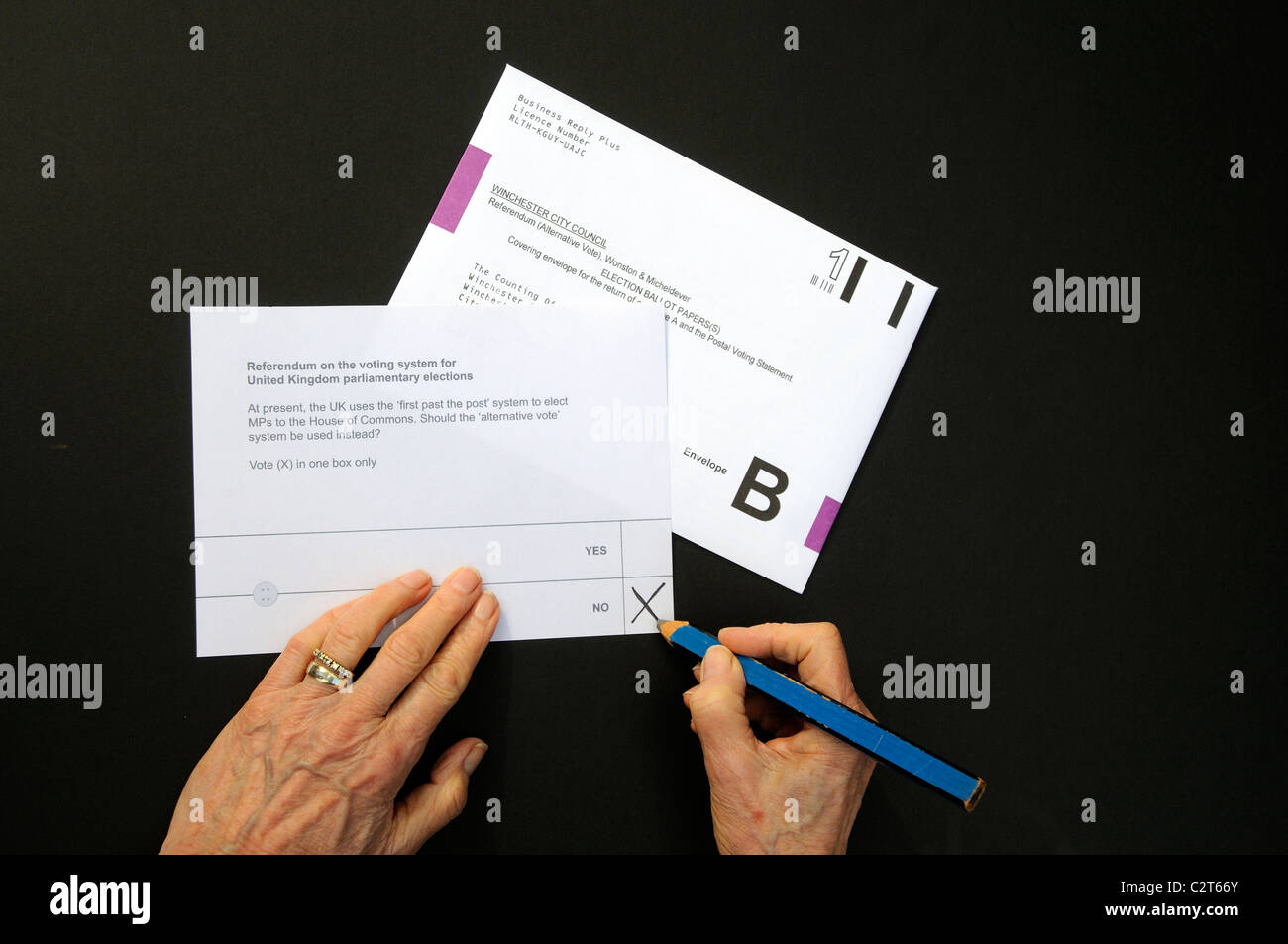 Referendum postal voting paper female hand puts a X in the No box Stock Photo