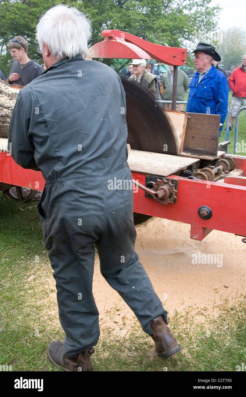 Men demonstrating the Cutting of wood with Tractor driven Rack Saw   Old Working Farm Machinery Stock Photo