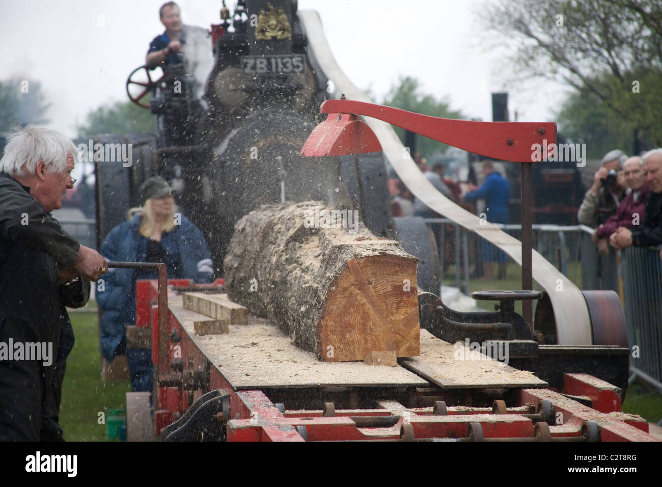 Men demonstrating the Cutting of wood with Tractor driven Rack Saw   Old Working Farm Machinery Stock Photo