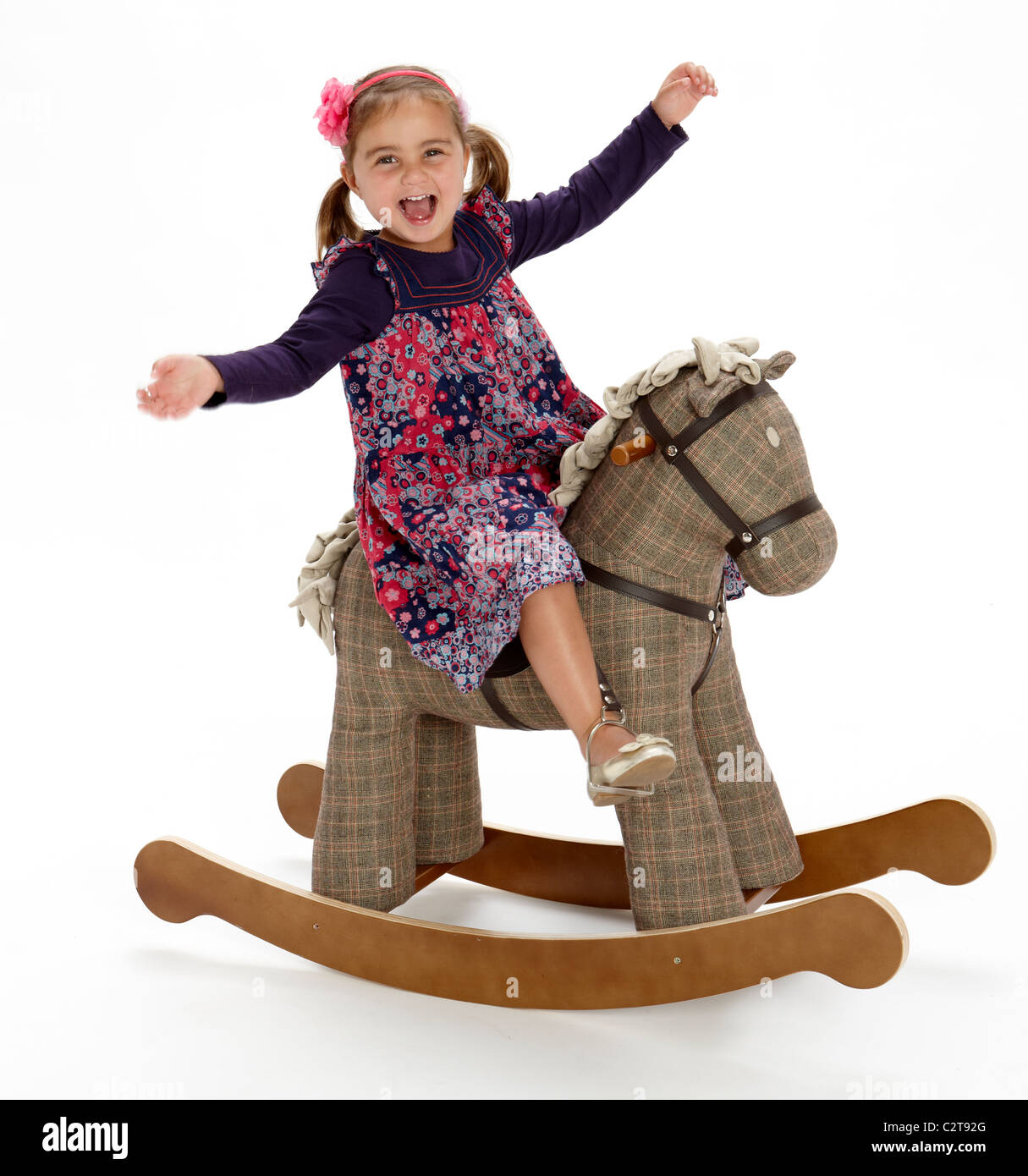 Little girl playing rocking horse pony rocker Stock Photo