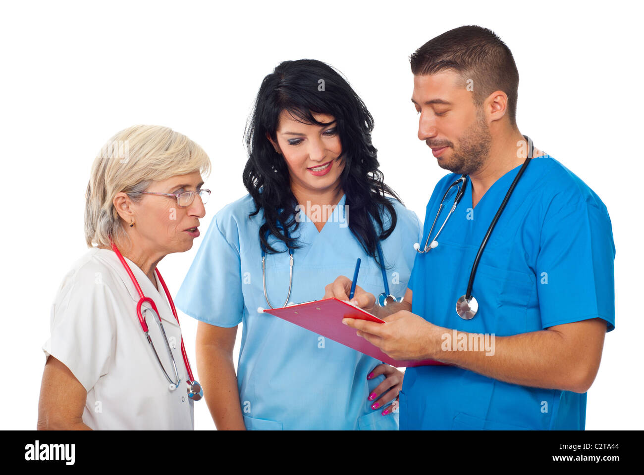 Three diverse doctors having a discussion ,writing and reading on clipboard and smiling satisfied about results isolated Stock Photo