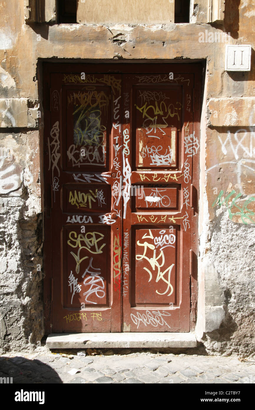 lots of covered graffiti on wooden door Stock Photo - Alamy