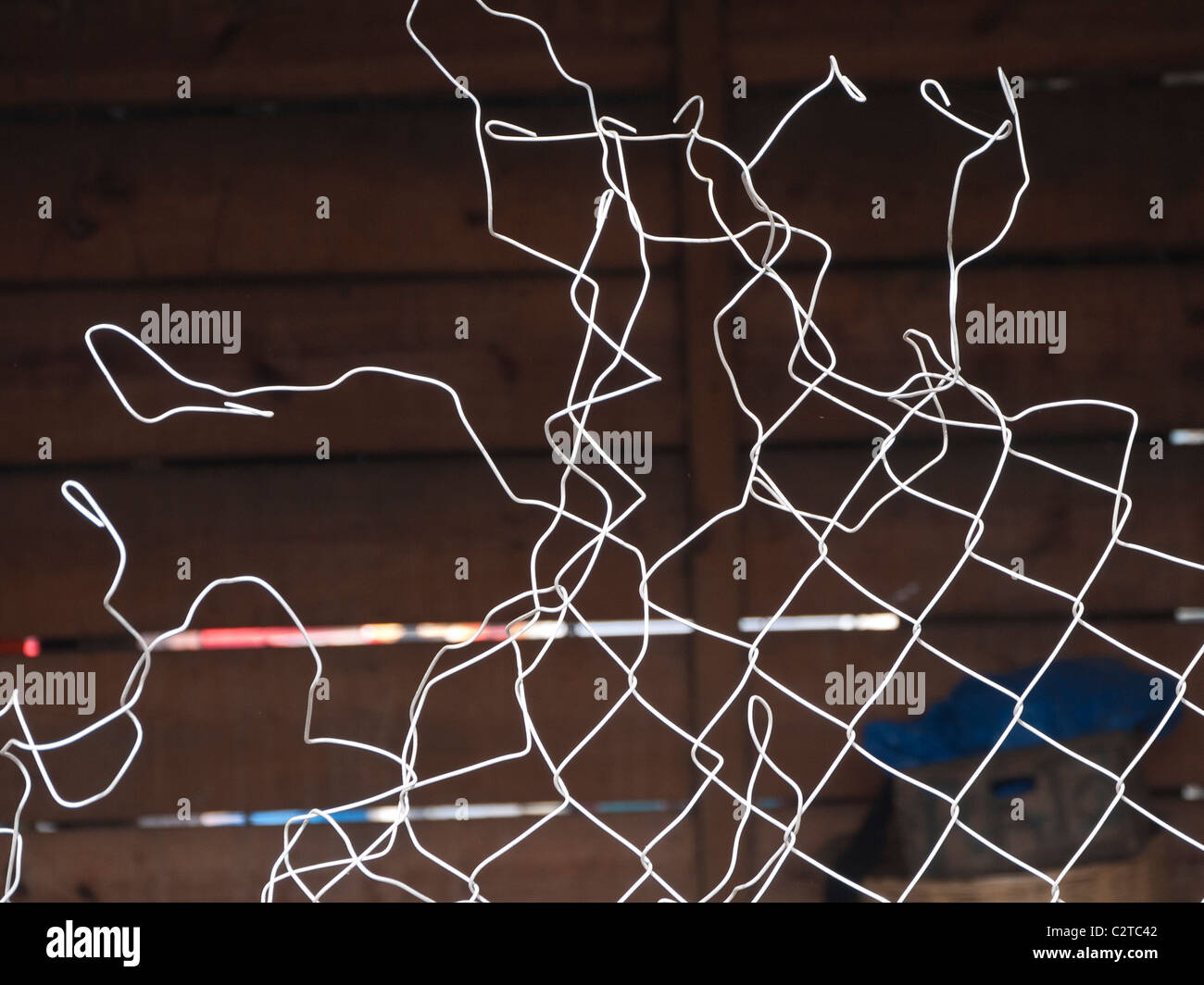 A graphic, artistic display of the bend wire in a chain link fence in