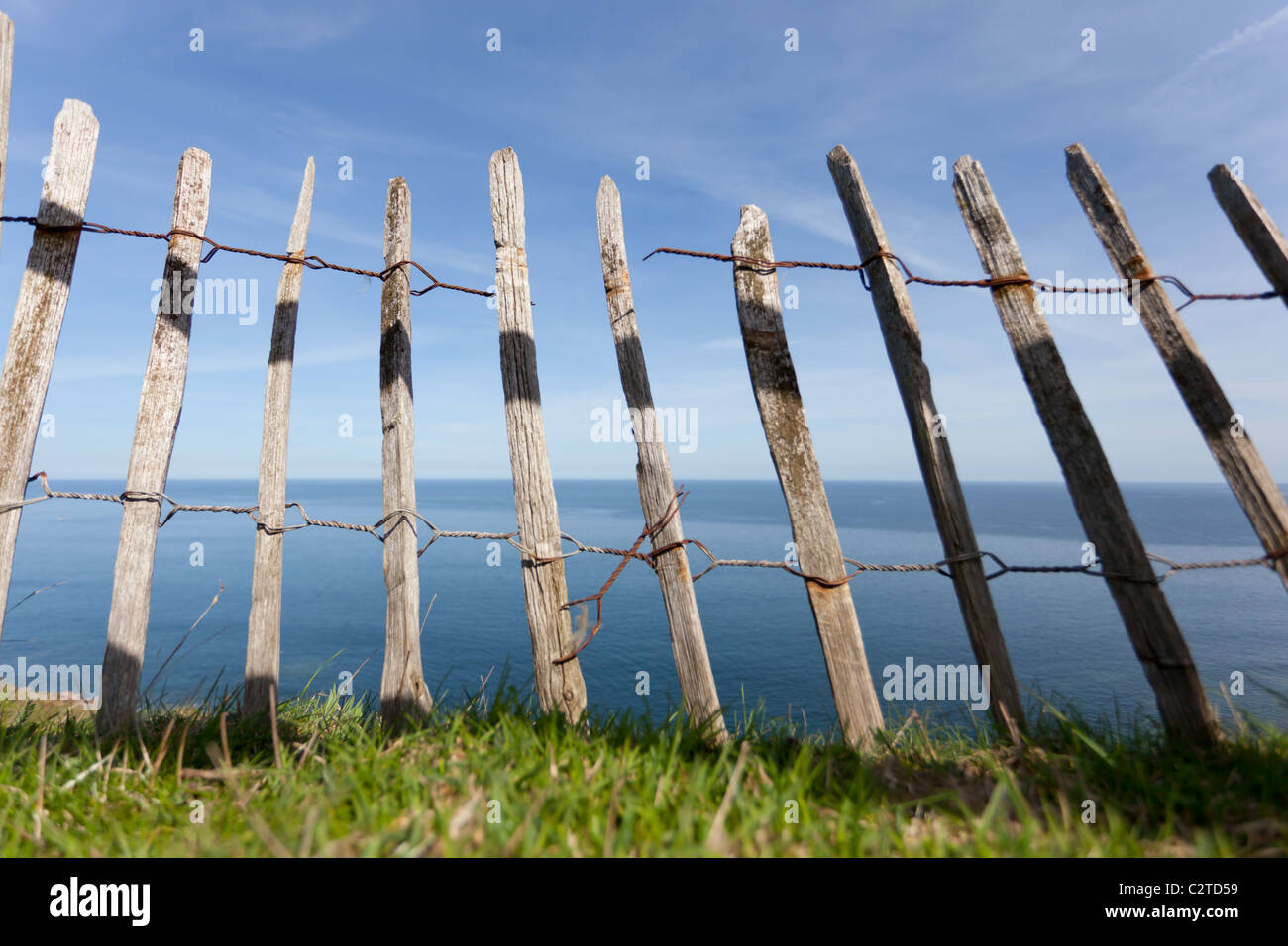 An old falling down fence protecting a cliff side path on the
