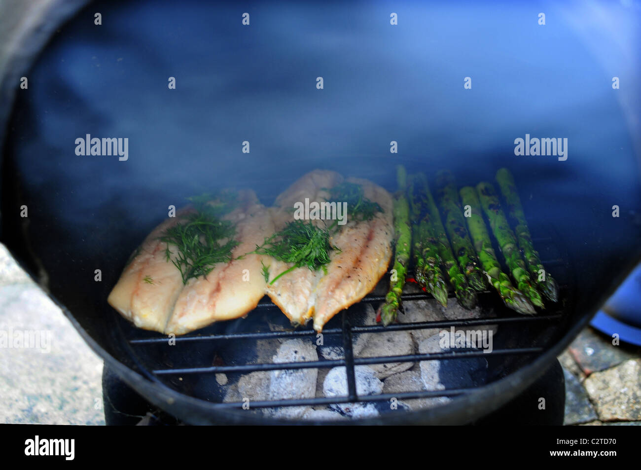 Mackerel fillets and asparagus cooking on a Cast Iron Garden Chimenea