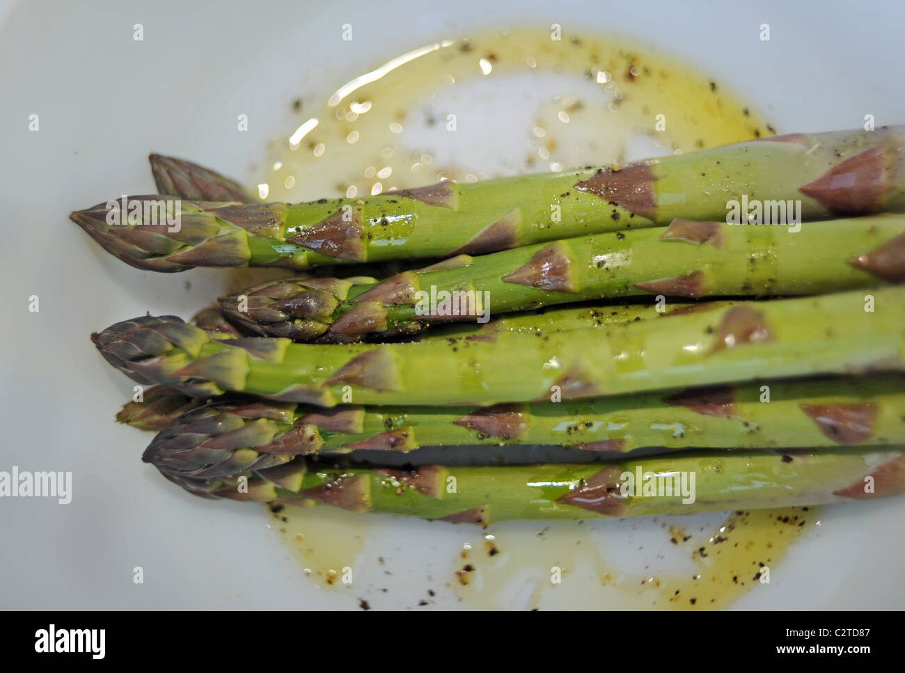 Asparagus ready for cooking on a barbeque bbq Stock Photo Alamy