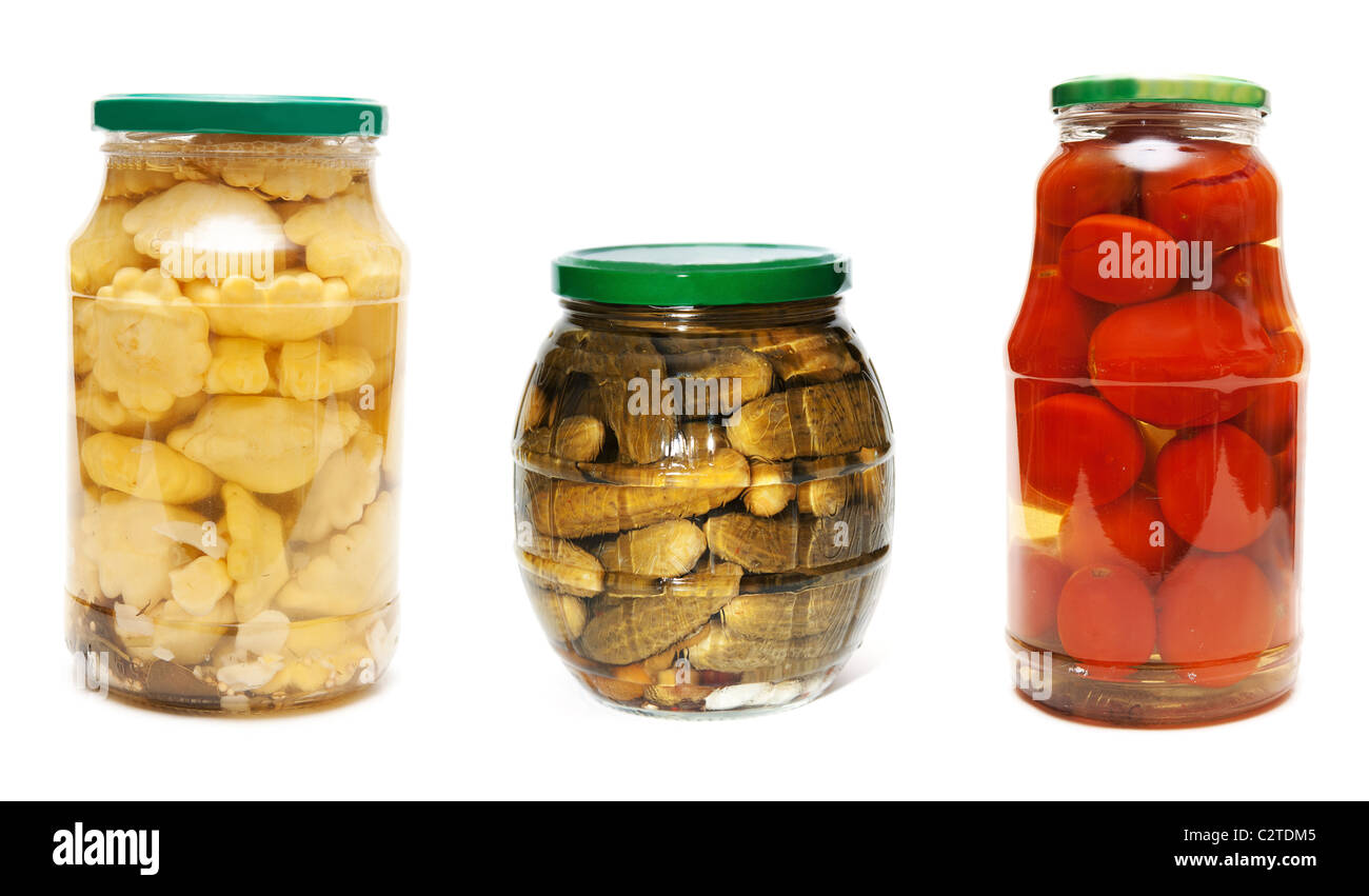 collage three jars of pickled vegetables isolated on a white background. The image is composed of several photographs. Stock Photo