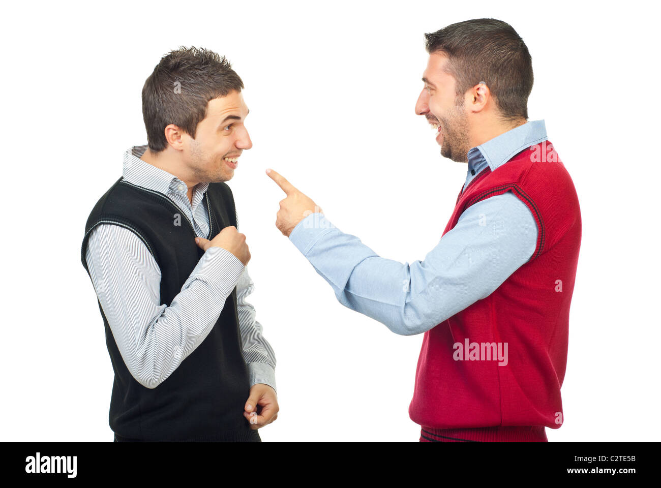 Two men laughing and have fun while one of them accusing the other and pointing to him isolated on white background Stock Photo