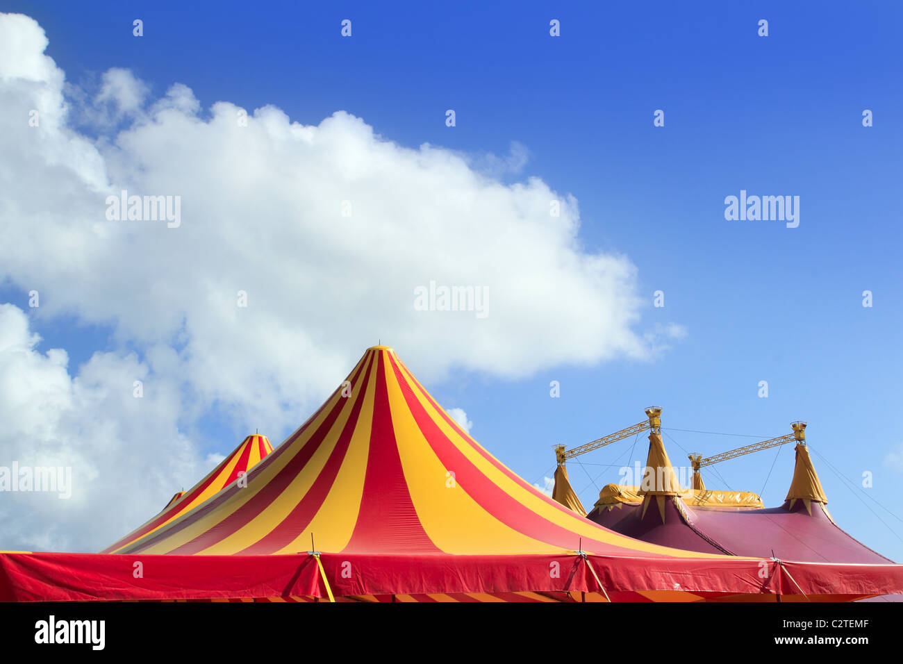 Circus tent red orange and yellow stripped pattern blue sky Stock Photo