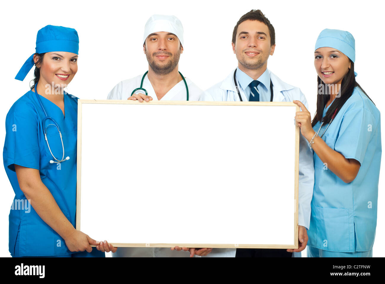 Four smiling different doctors holding a blank banner Stock Photo