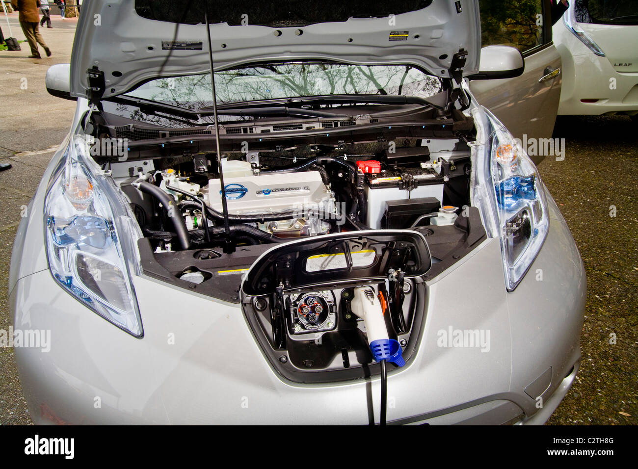 Engine compartment and charging port of the Nissan Leaf, a five-door mid-size hatchback all-electric zero-emissions car. Stock Photo