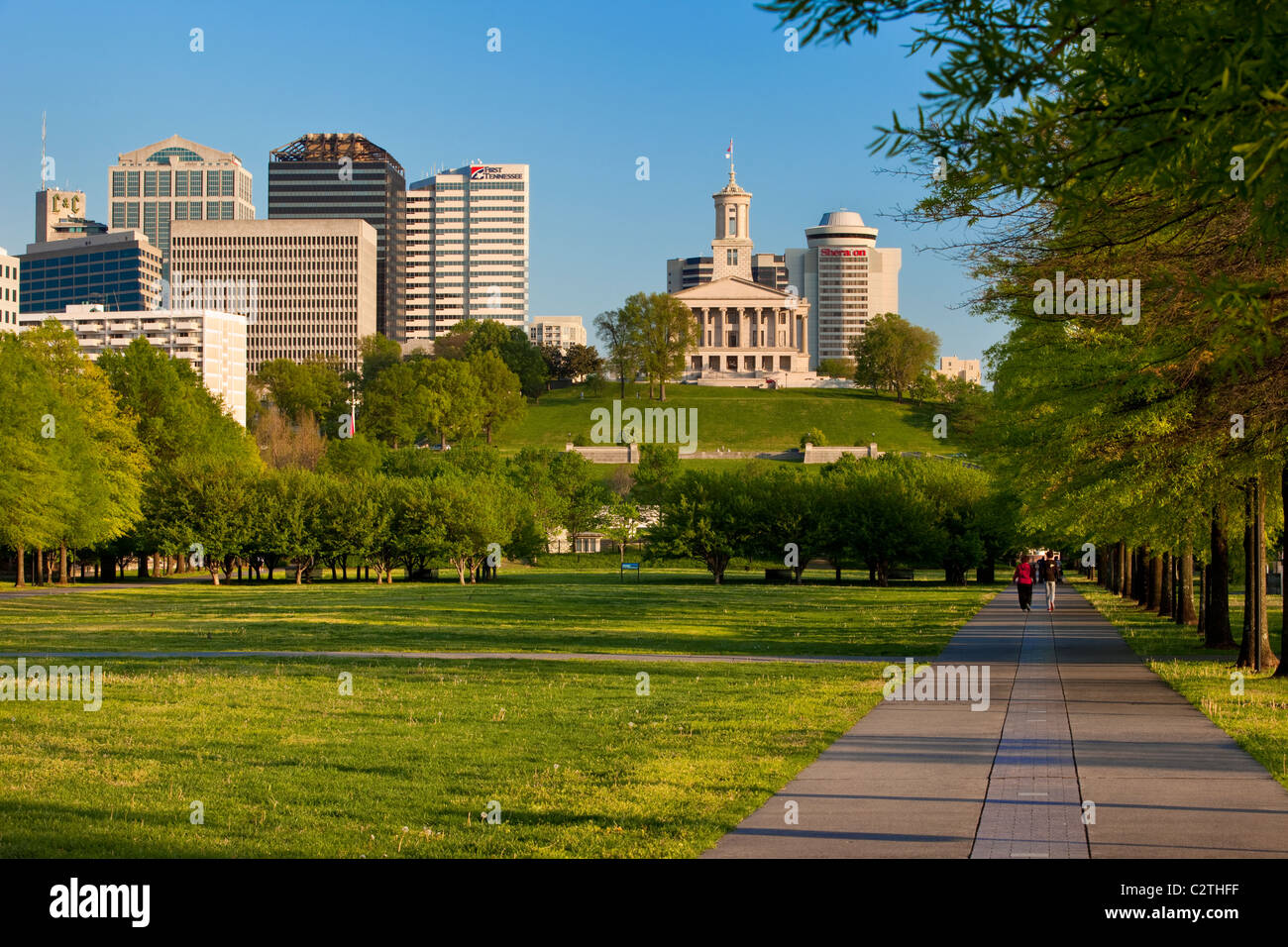 A couple walks along the pathway through Bicentennial Park below the Capitol Building in downtown Nashville Tennessee, USA Stock Photo