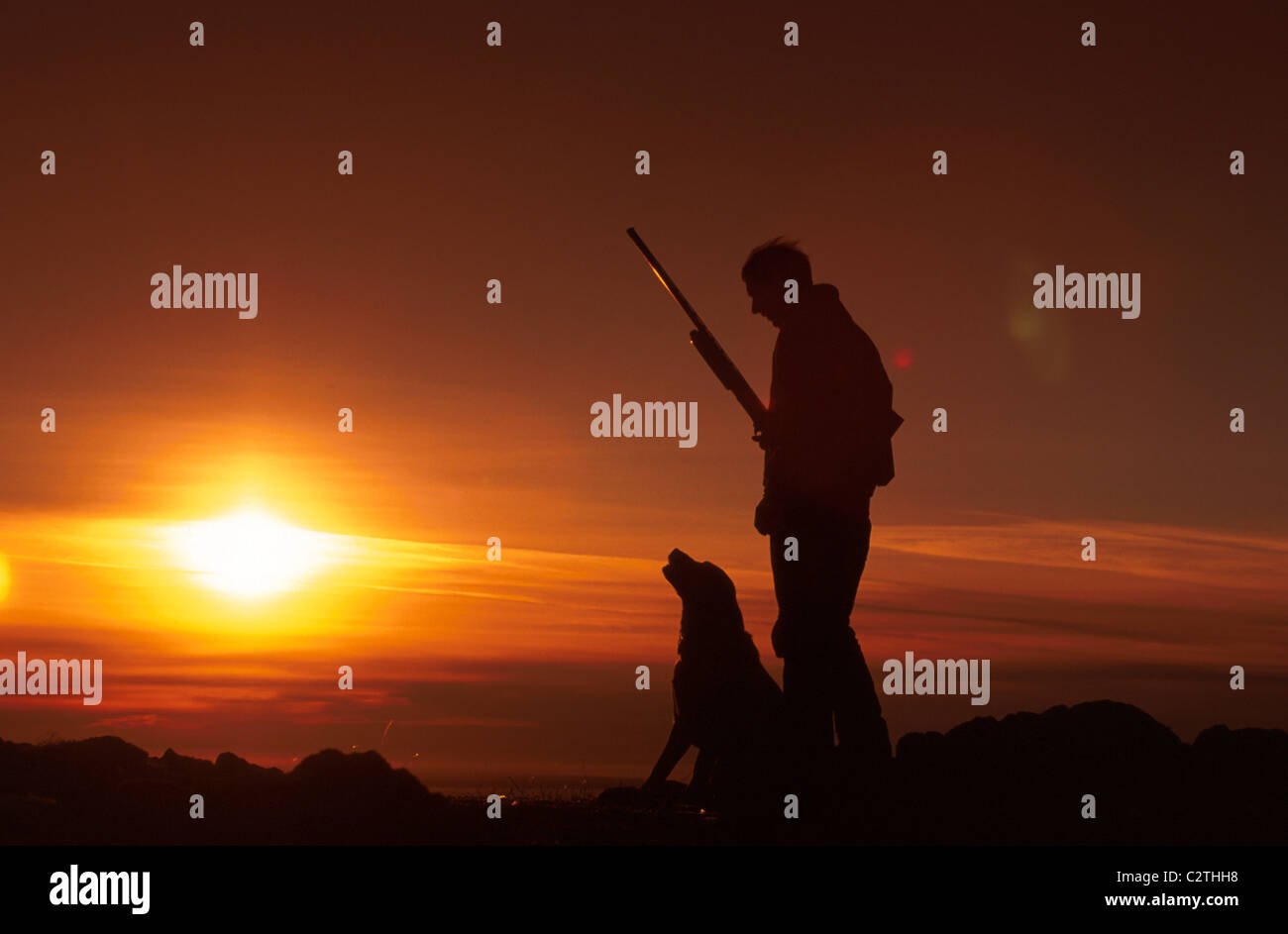 Silhouett of Man Hunting Sunset Chugach SP SC AK W & w/o Dog Stock Photo
