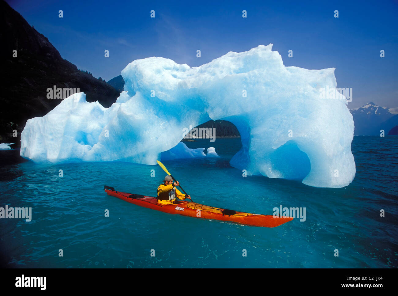 Sea Kayaker Approaches Iceberg Tracy Arm SE AK Summer Fords-Terror Wilderness Area Stock Photo