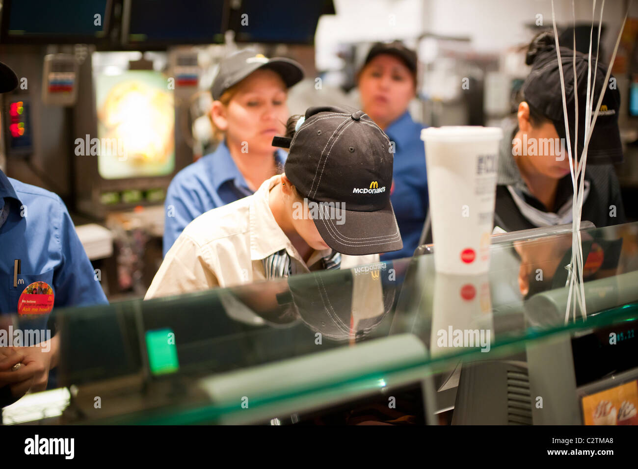 Employees of a McDonald's restaurant in New York serve customers Stock ...