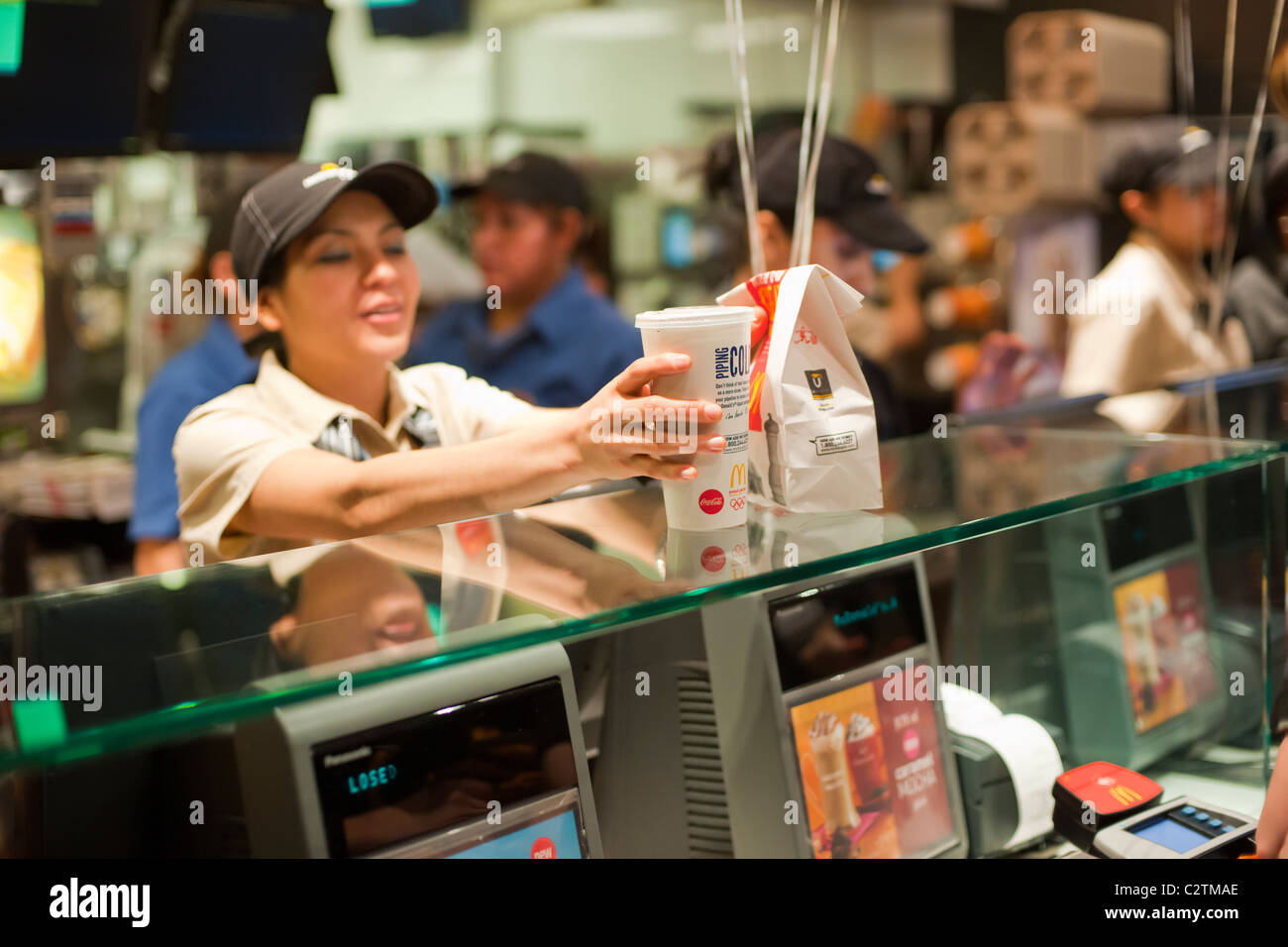 Employees of a McDonald's restaurant in New York serve customers Stock