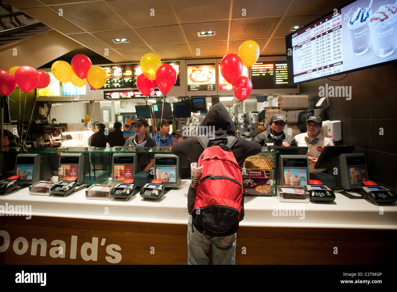 Employees of a McDonald's restaurant in New York serve customers Stock