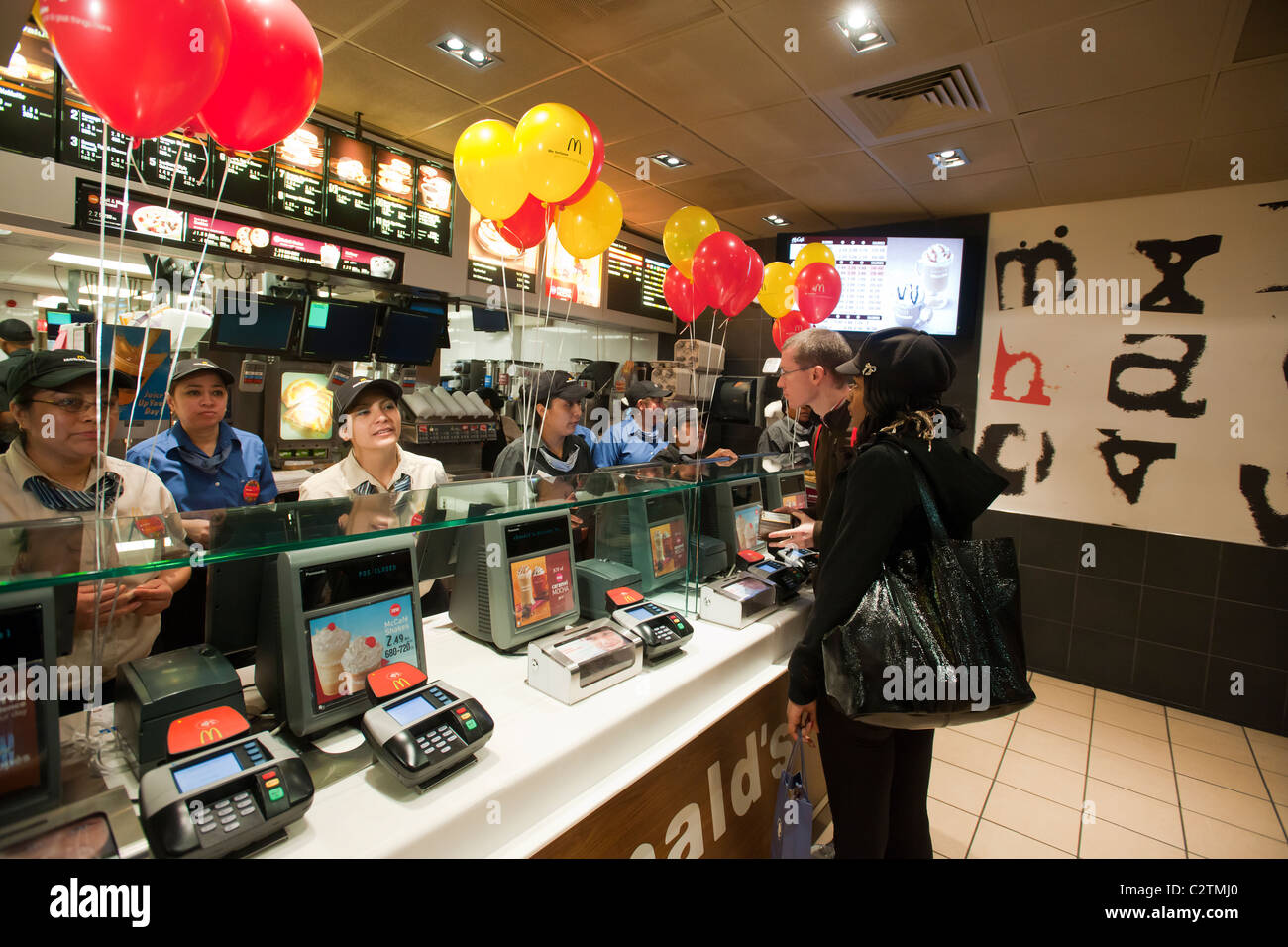 Employees of a McDonald's restaurant in New York serve customers Stock