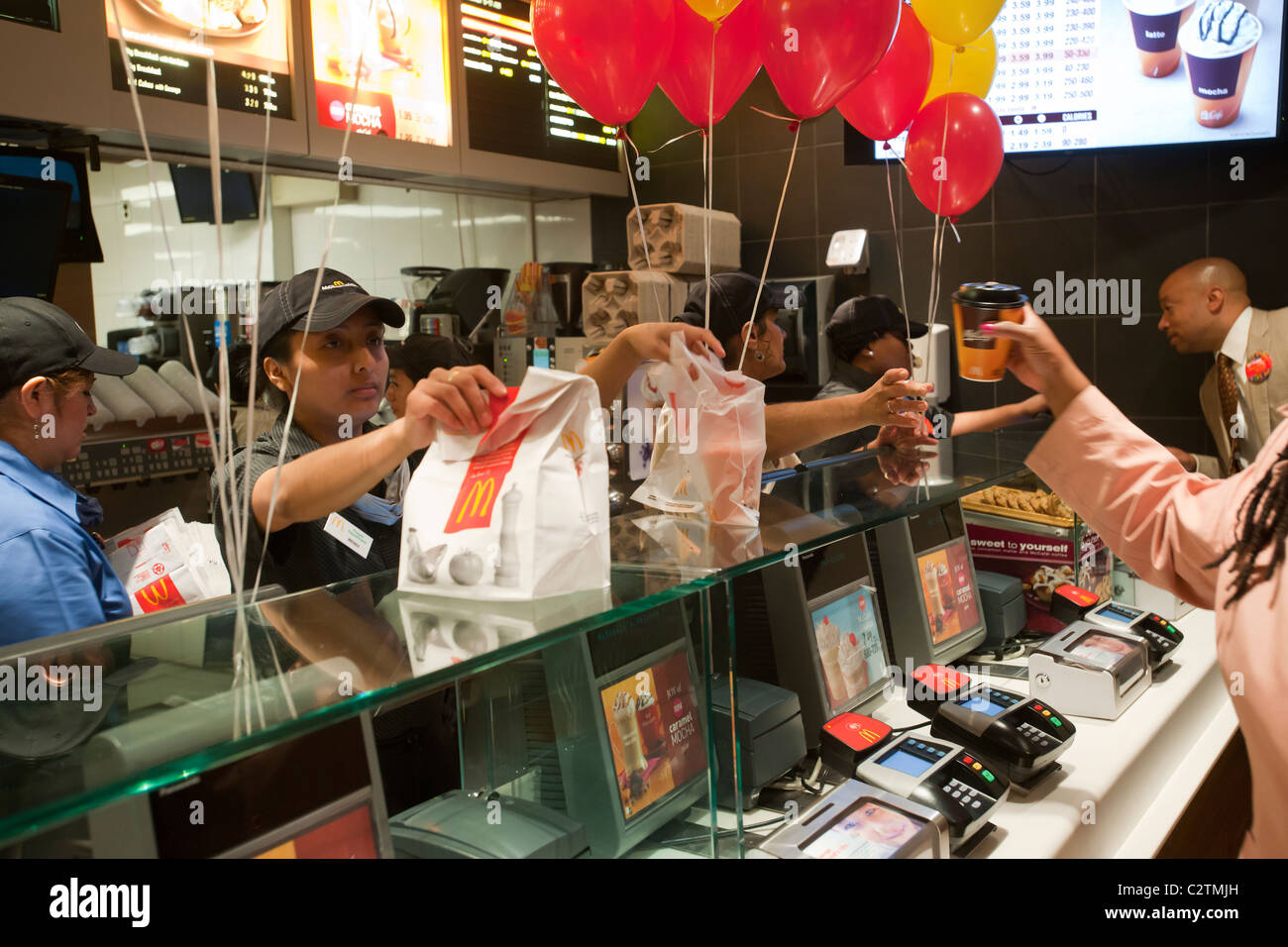 Employees of a McDonald's restaurant in New York serve customers Stock ...