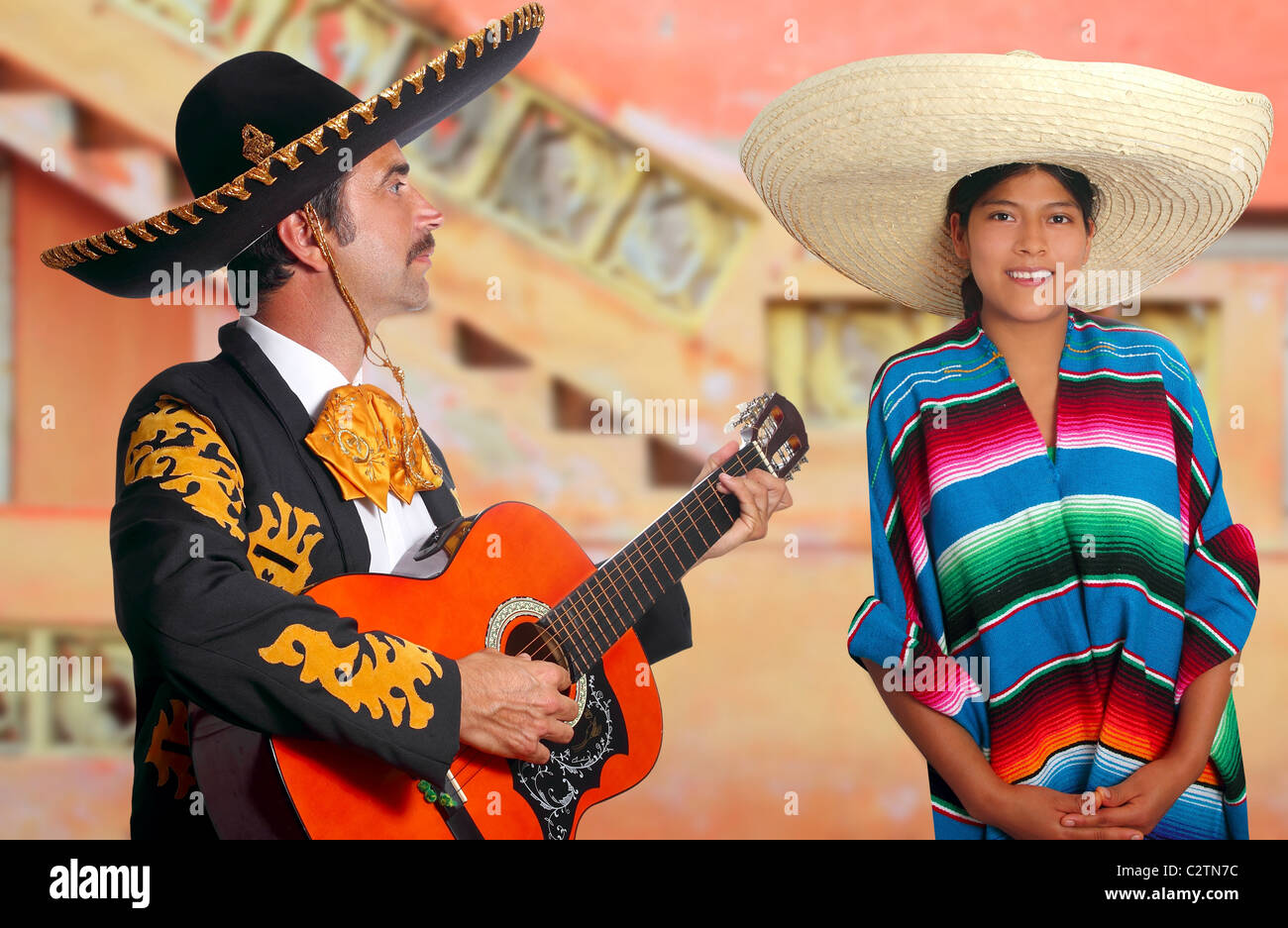 Mexican mariachi charro man and poncho Mexico girl colorful facade houses  Stock Photo - Alamy