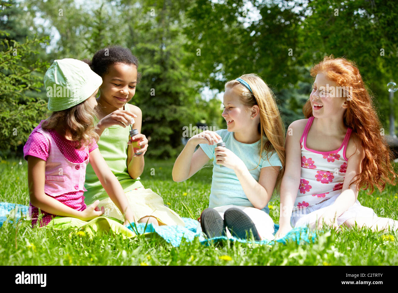 Portrait of cute girls having fun on green lawn in park Stock Photo - Alamy