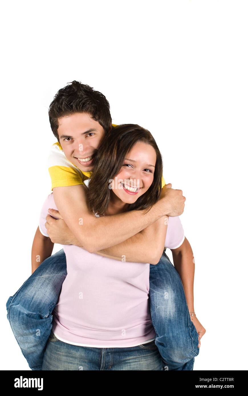 A young boy getting a piggyback ride from a teen girl and having fun ...