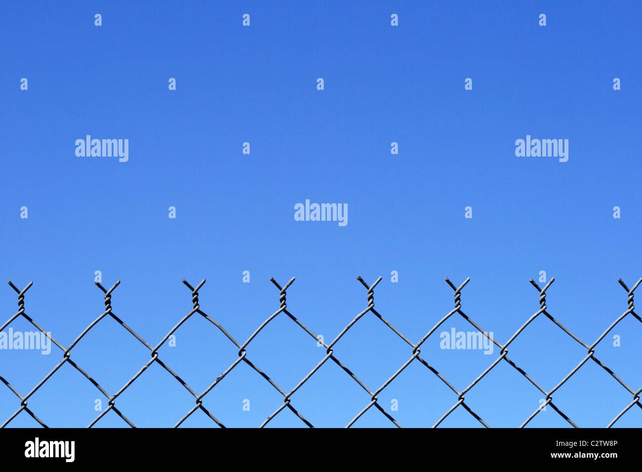 chain link fence top with blue sky background and copy space Stock Photo