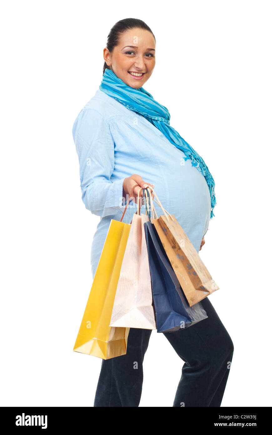 Cheerful pregnant woman nine months holding shopping bags isolated on white background Stock Photo