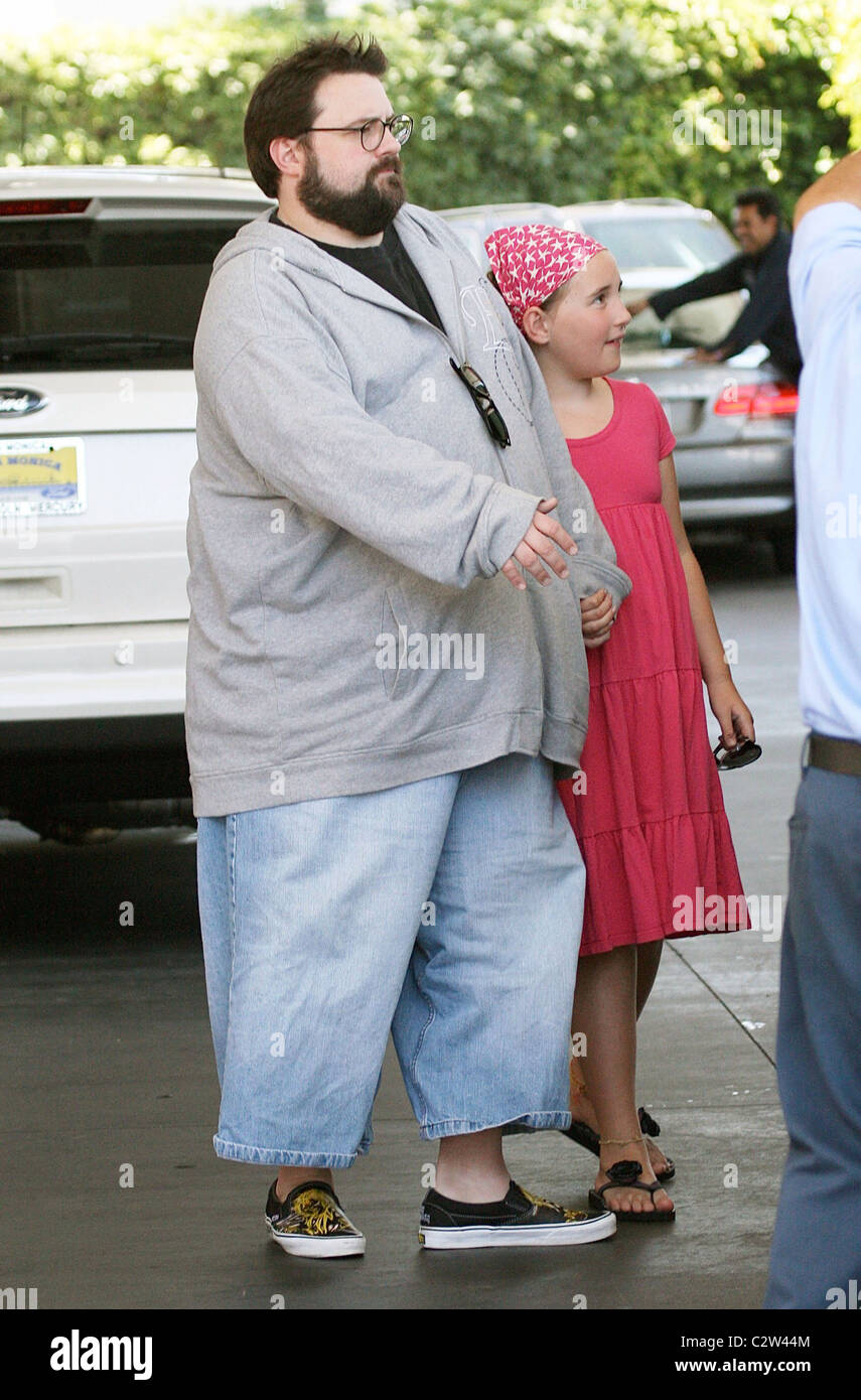 Kevin Smith director wearing long shorts stops at a petrol station in  Beverly Hills with his daughter Los Angeles, California Stock Photo - Alamy