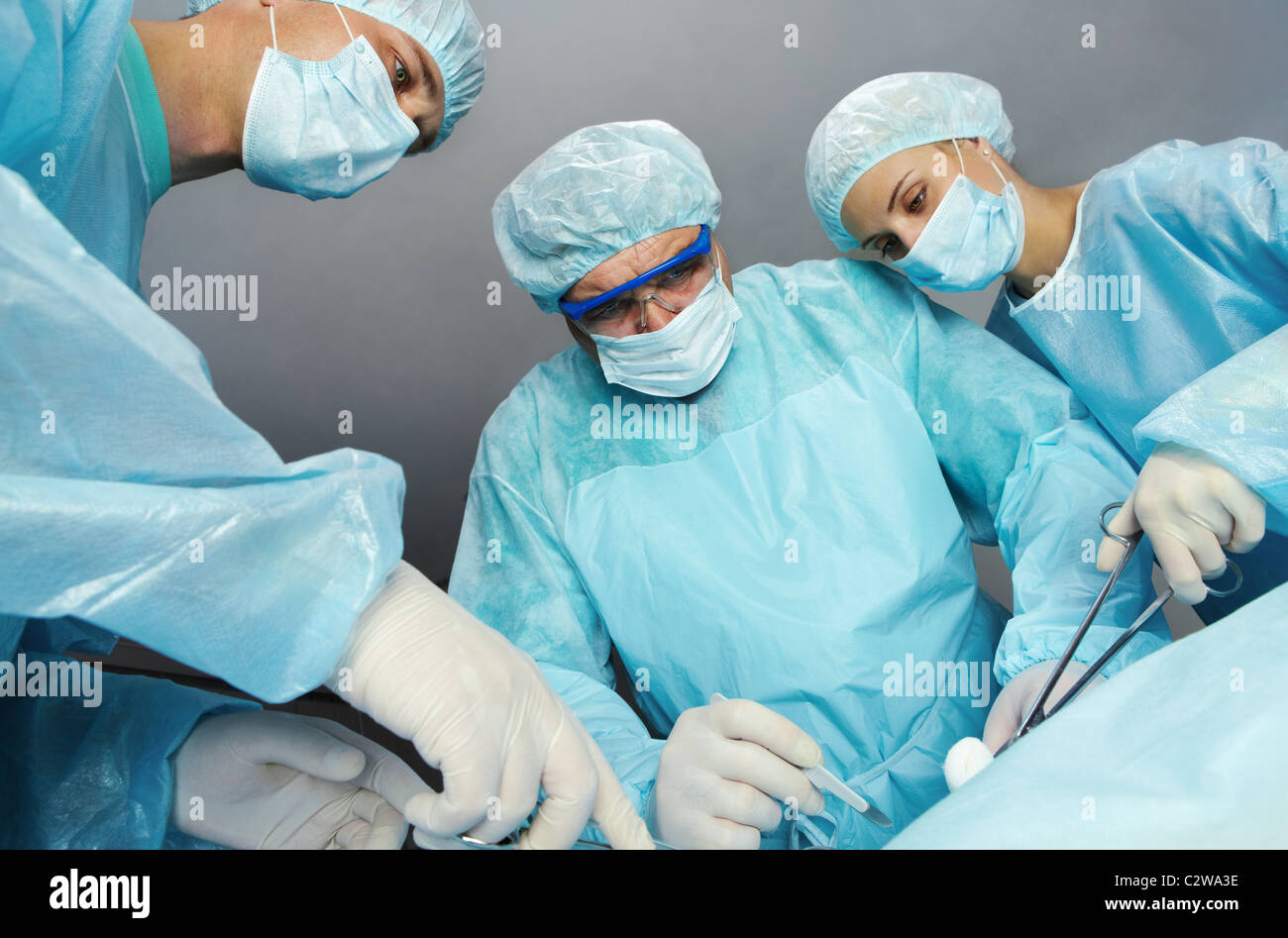 Bottom view of three surgeons operating Stock Photo