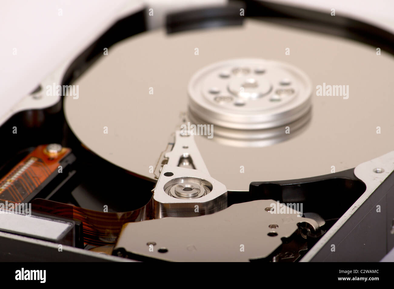 Close up of open hard disk drive, cylinders and heads Stock Photo