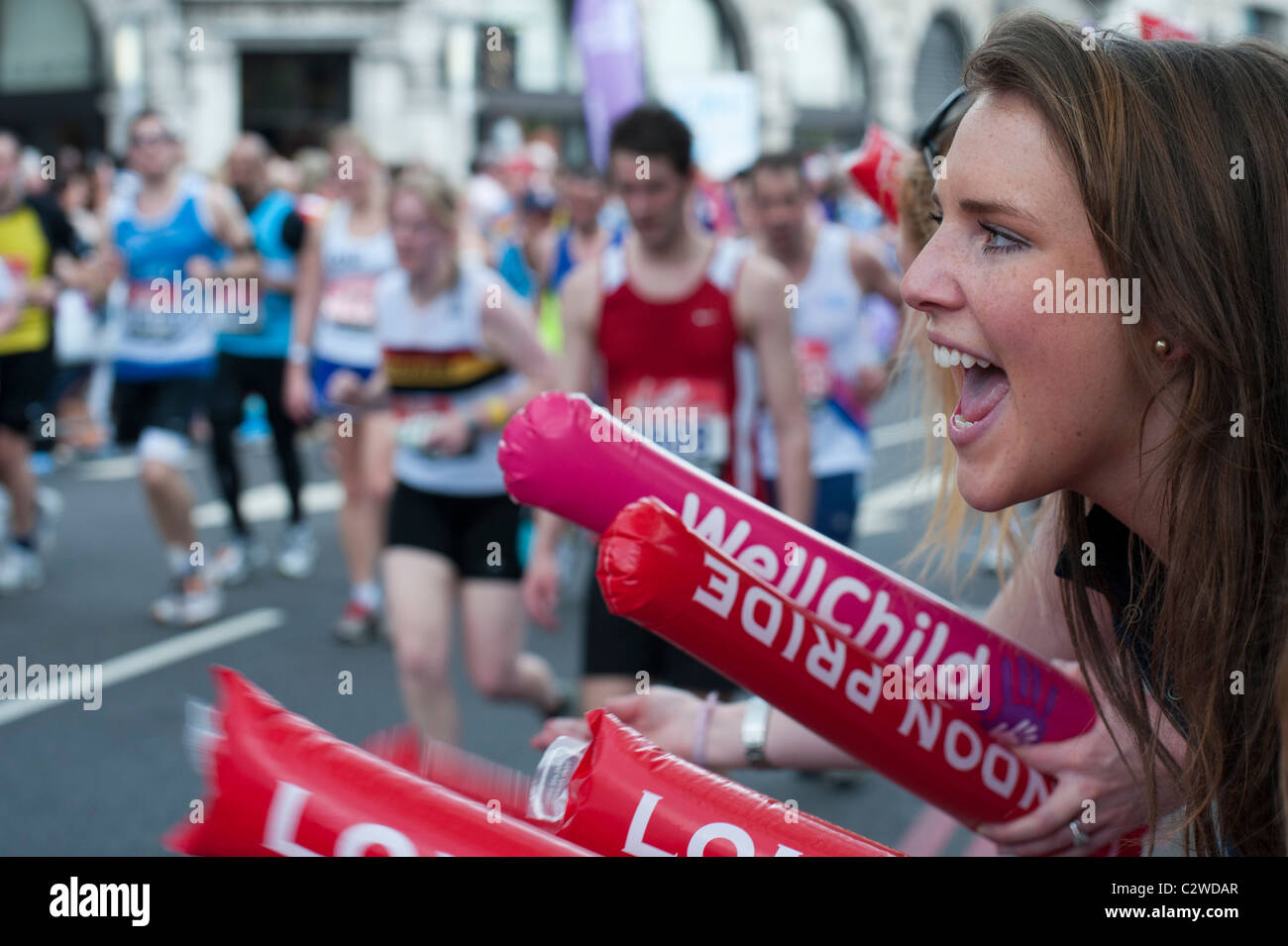 Girls cheering on runners in the London Marathon 2011 Stock Photo