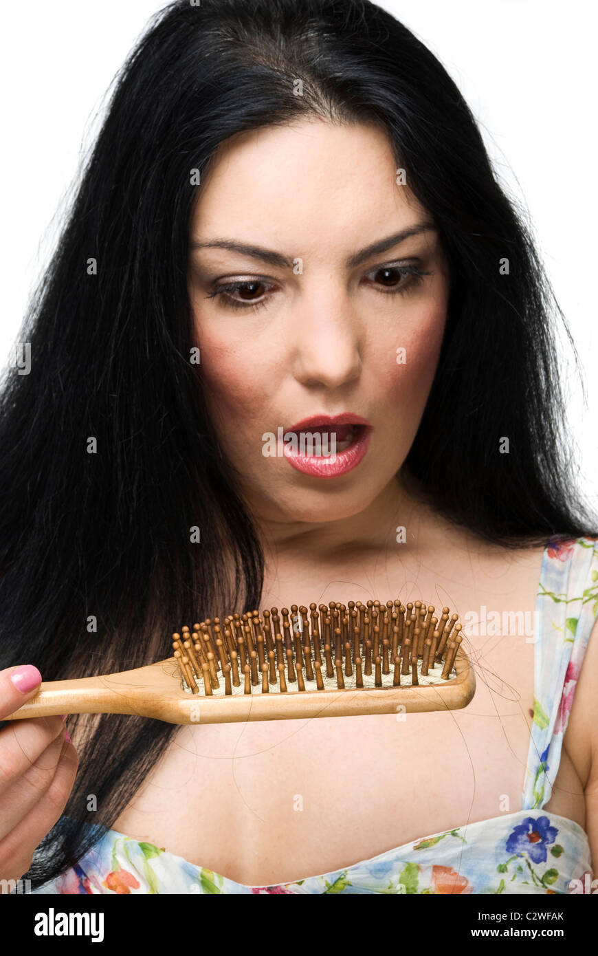 Shocked woman discover how much hair loss on hairbrush,focus on