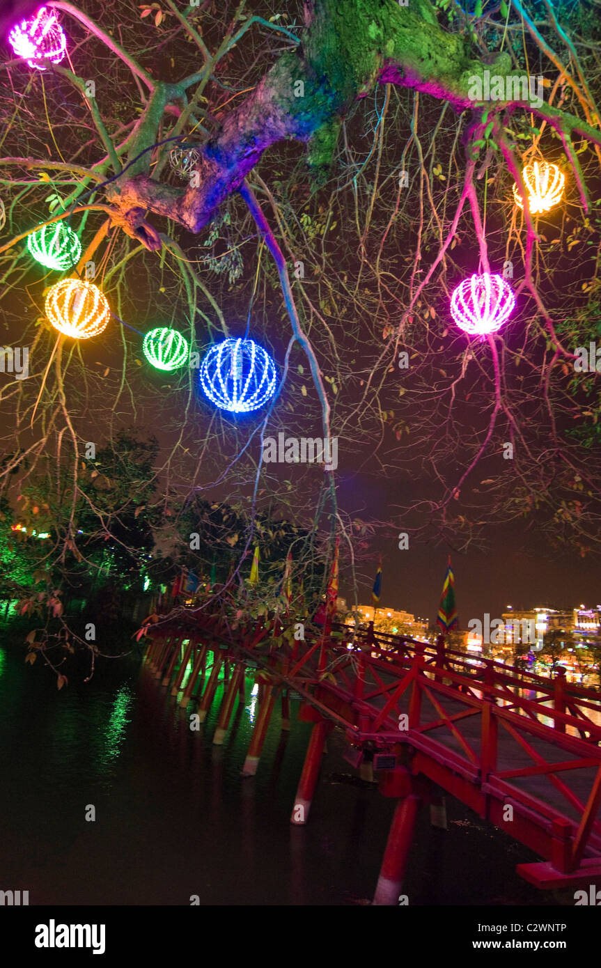 Vertical night time close up of Thê Húc bridge at Ngoc Son Temple on Hoan Kiem Lake in central Hanoi. Stock Photo