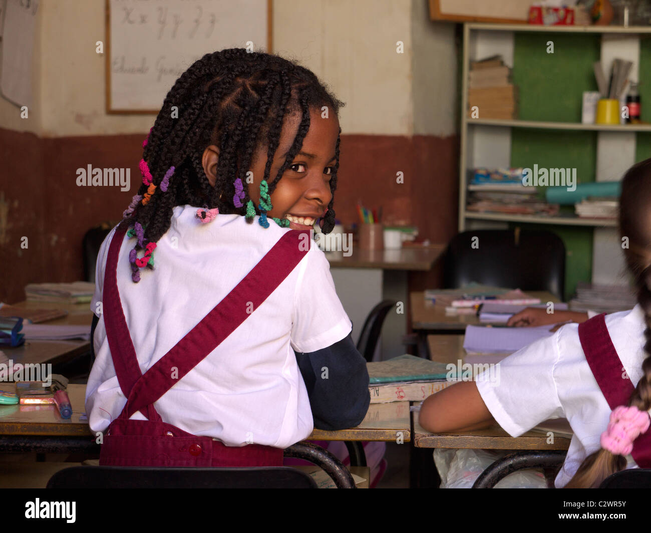 Young schoolgirl sitting in a classroom Stock Photo - Alamy