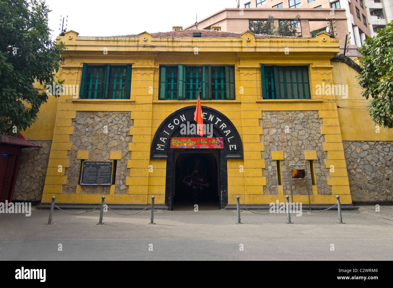 Horizontal view of Hoa Lo Prison Museum historically known as the Hanoi Hilton in central Hanoi on a sunny day. Stock Photo