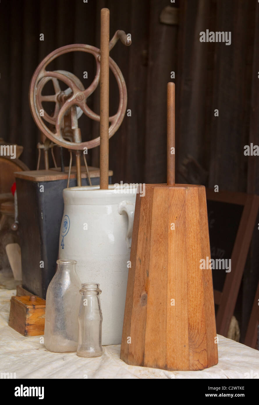 A vintage butter churn and milk bottles Stock Photo