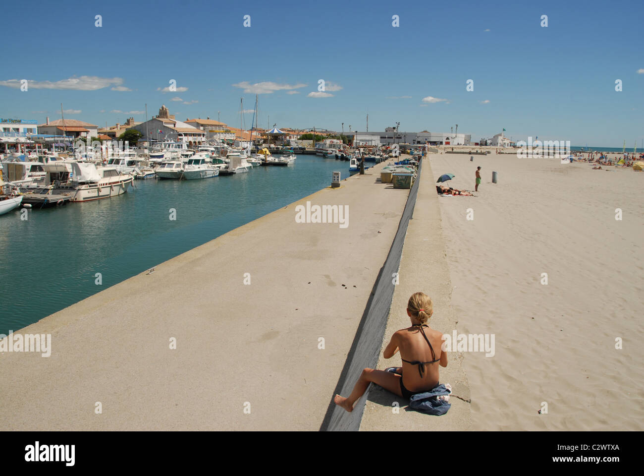 Sandy beach and port of Les Saintes Maries-de-la-Mer: in Camargue, Bouches du Rhône in southern France Stock Photo