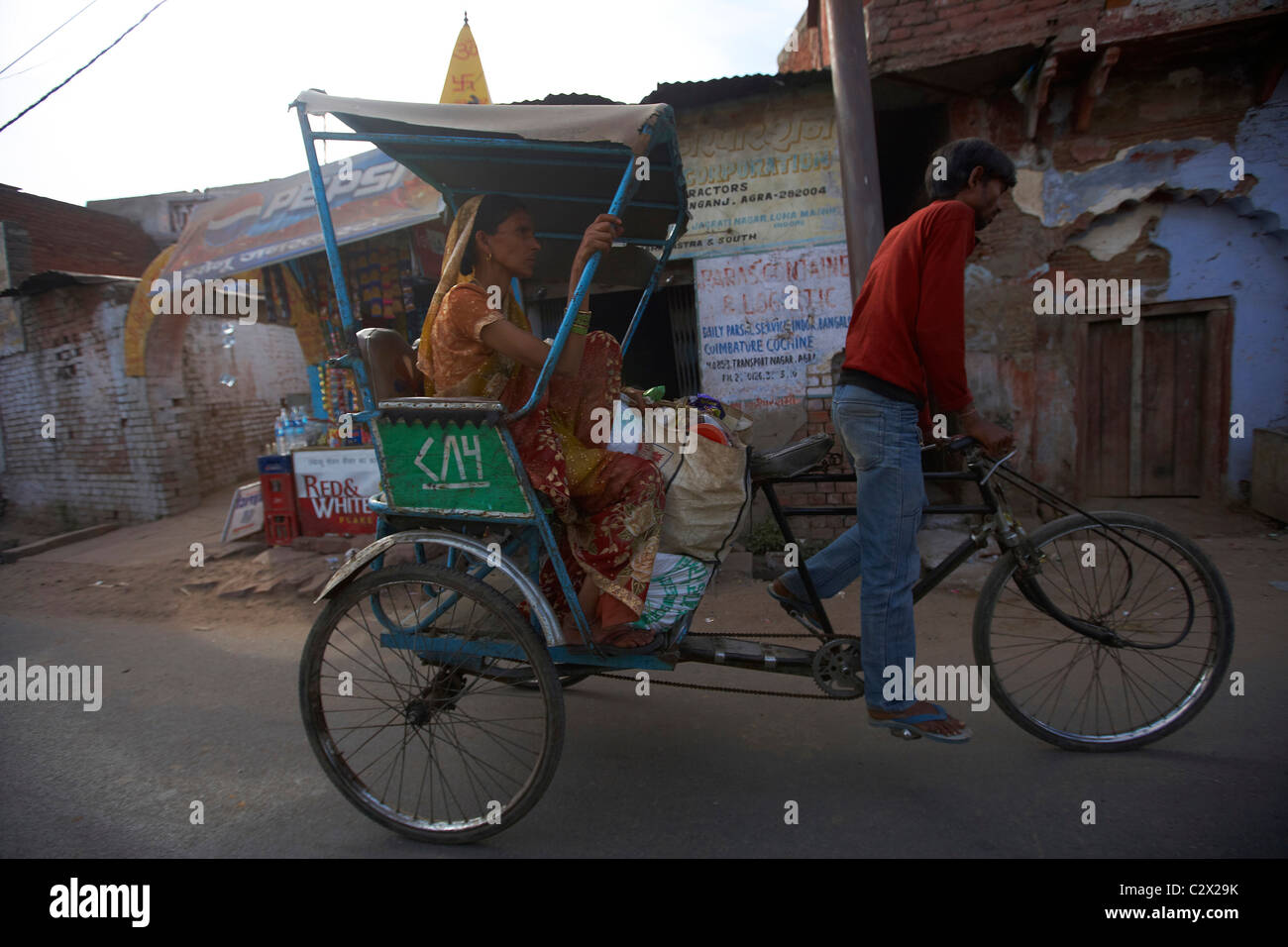 Rickshaw and woman passenger. Agra street scene, Uttar Pradesh, India ...