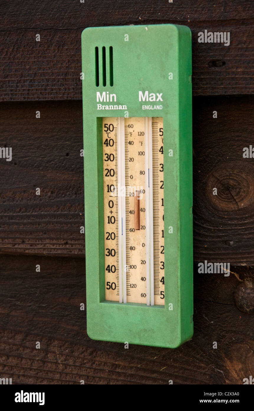 A maximum minimum thermometer on a garden shed Stock Photo