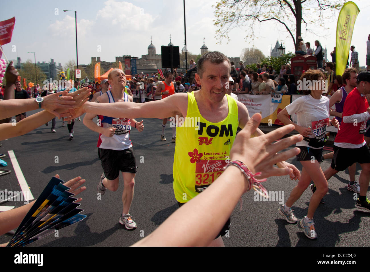A charity runner in the 2011 London Marathon, and his supporters Stock Photo