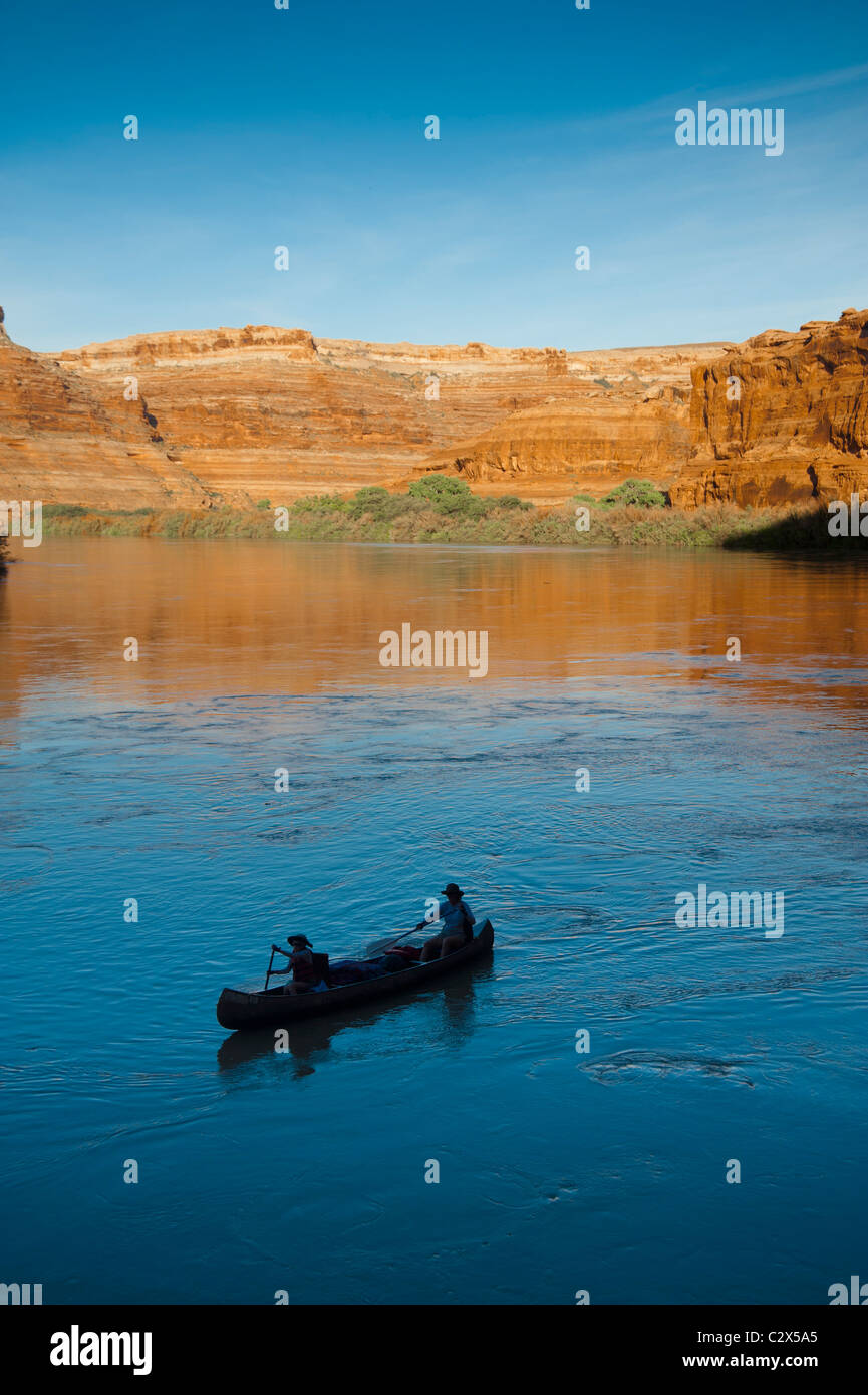 Mother and daughter canoeing on a calm blue river in the desert Stock Photo