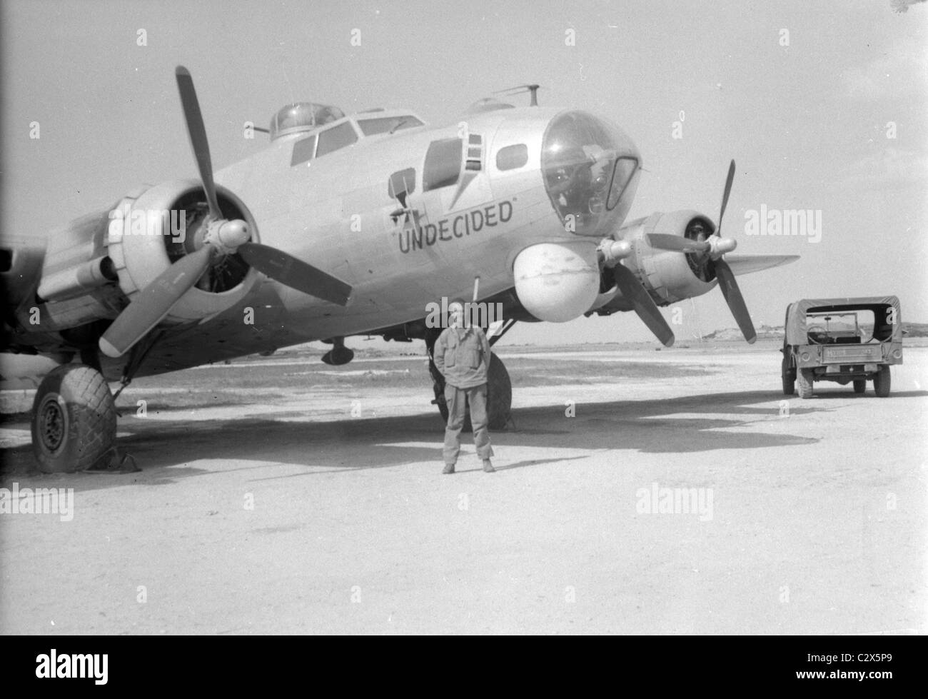 American GI standing next to B29 with nose art in photograph made on Okinawa in circa 1945 after the U.S. invasion. Stock Photo