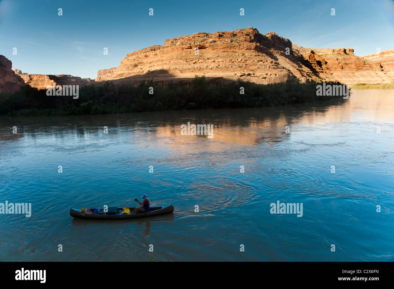 Man in a canoe on a desert river Stock Photo